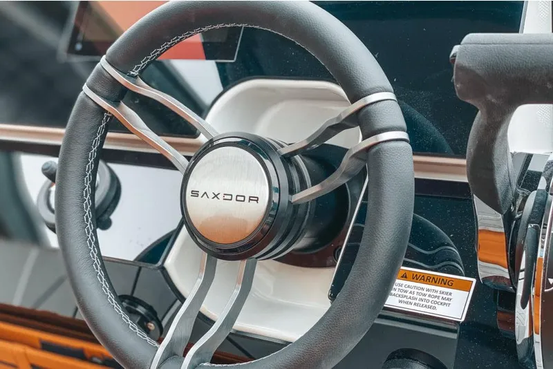Slide: The Image of 2023 Saxdor 200 SPORT steering wheel and dashboard close-up. - 3