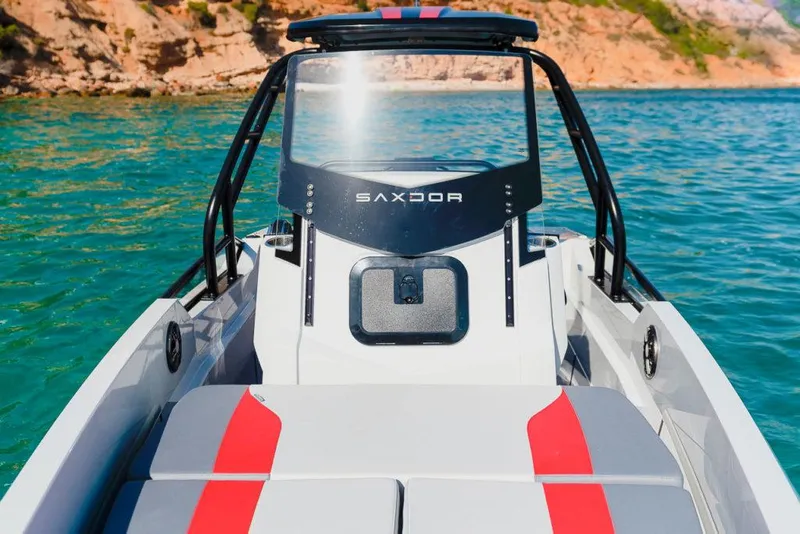 Slide: The Image of 2023 Saxdor 200 Pro Sport boat on clear blue water. - 12