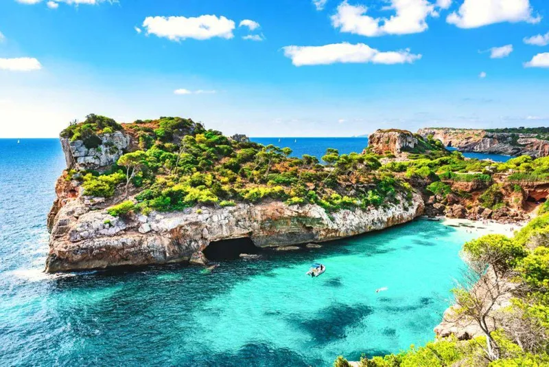 Slide: The Image of 2023 Saxdor 200 Pro Sport in turquoise waters near rocky coastline and lush greenery. - 3