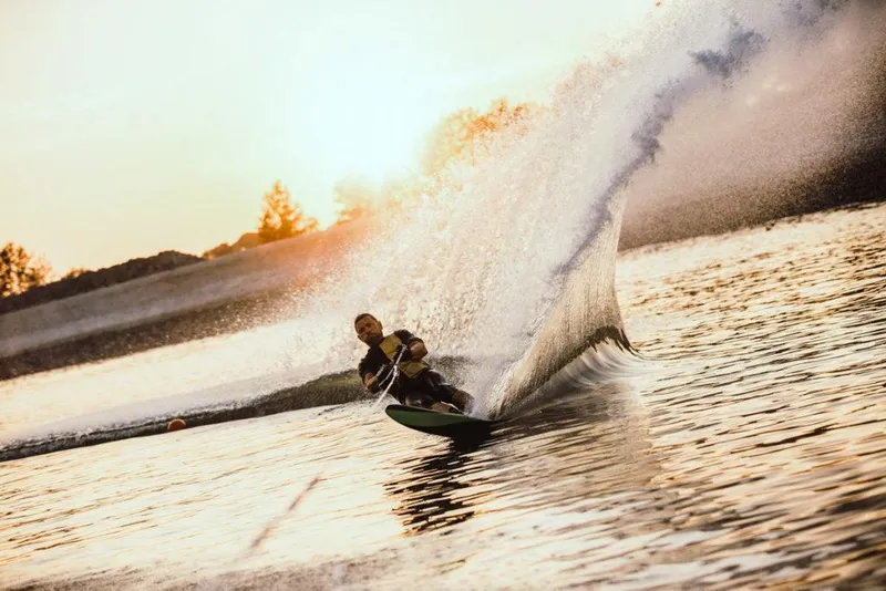 Slide: The Image of Person waterskiing at sunset, creating a large spray on a Saxdor 200 Pro Sport, 2023. - 5
