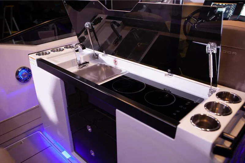 Slide: The Image of Saxdor 320 GTO 2023 boat kitchen with sink, stove, and cup holders. - 11