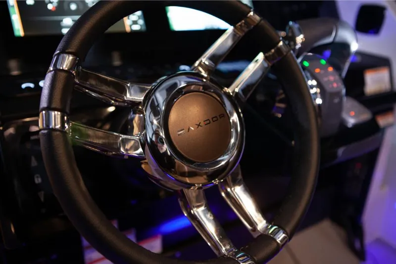 Slide: The Image of Close-up of 2023 Saxdor 320 GTO steering wheel and dashboard controls. - 23