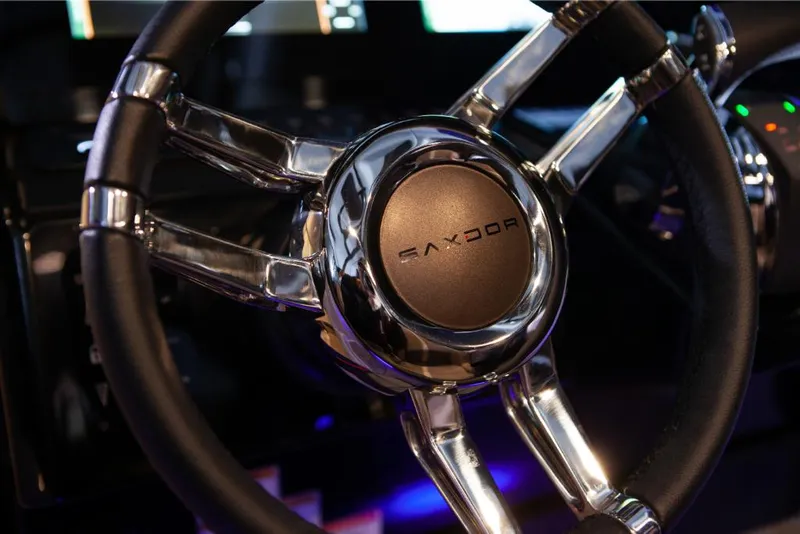 Slide: The Image of Close-up of 2023 Saxdor 320 GTO steering wheel with chrome accents. - 24