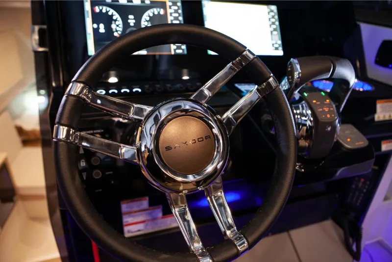 Slide: The Image of 2023 Saxdor 320 GTO steering wheel and dashboard controls. - 25
