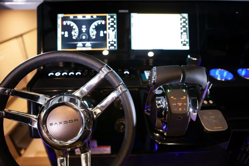 Slide: The Image of Saxdor 320 GTO 2023 dashboard with steering wheel and control panel. - 26