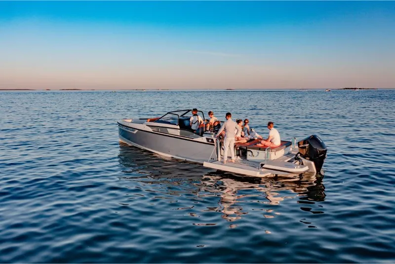 Slide: The Image of 2023 Saxdor 320 GTR boat with people enjoying a calm sea. - 14