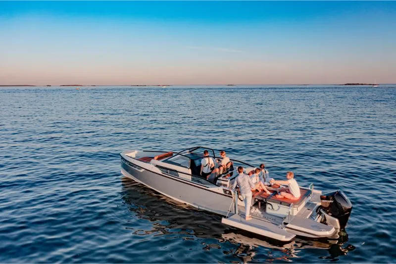 Slide: The Image of 2023 Saxdor 320 GTR boat with people enjoying a sunny day on the water. - 15