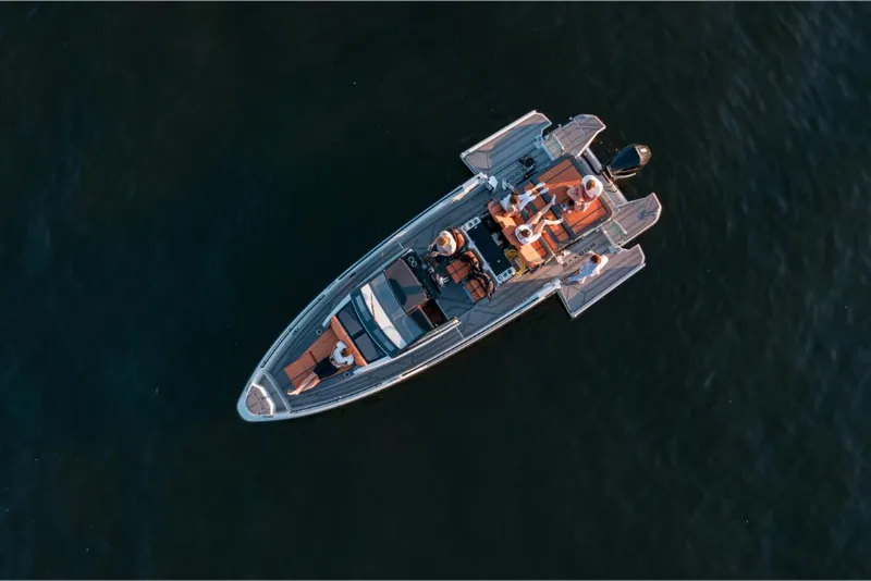Slide: The Image of Aerial view of 2023 Saxdor 320 GTR boat cruising on water. - 19