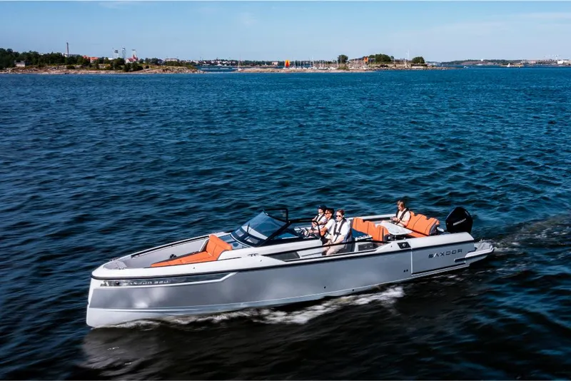 Slide: The Image of 2023 Saxdor 320 GTR boat cruising on open water with passengers. - 2