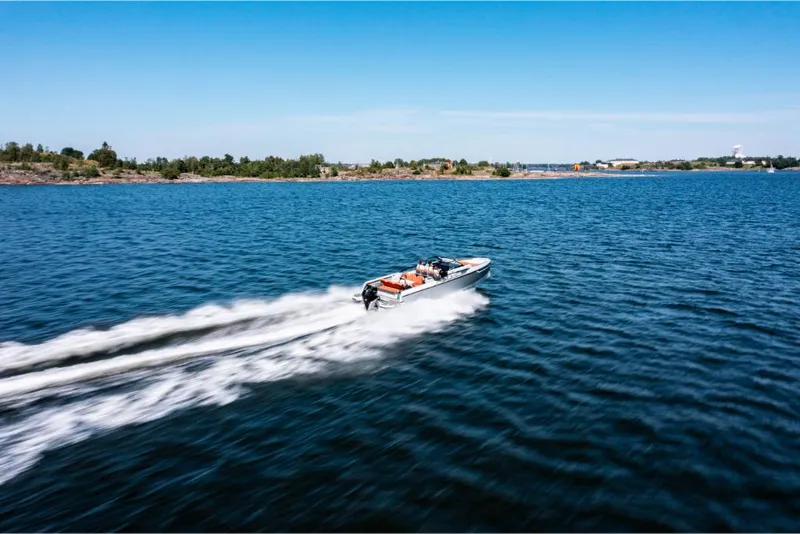 Slide: The Image of Saxdor 320 GTR 2023 speeding on a clear blue lake. - 7
