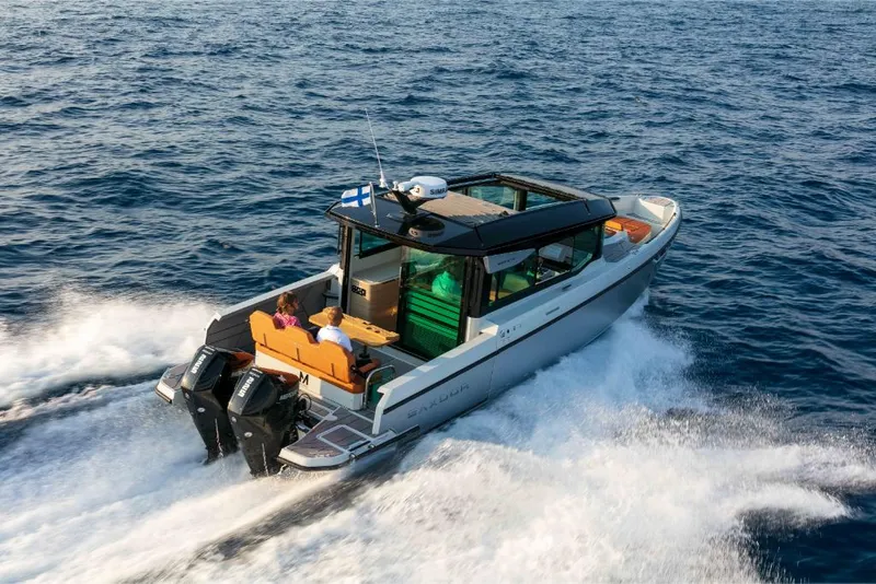 Slide: The Image of 2023 Saxdor 320 GTC motorboat cruising on open water. - 1