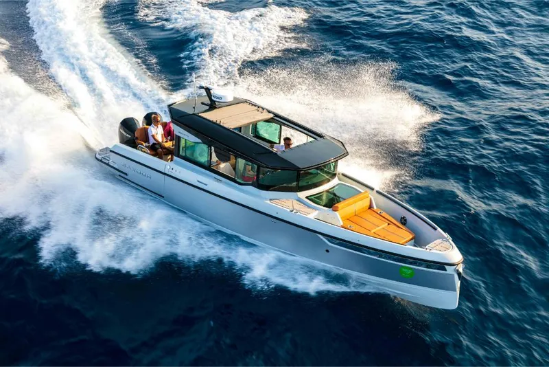Slide: The Image of 2023 Saxdor 320 GTC motorboat cruising on open water. - 14