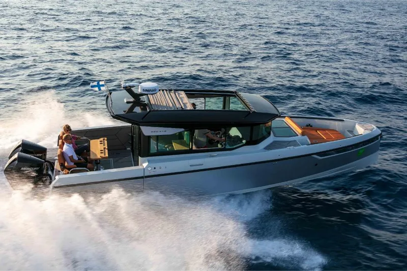 Slide: The Image of 2023 Saxdor 320 GTC motorboat cruising on open water. - 2