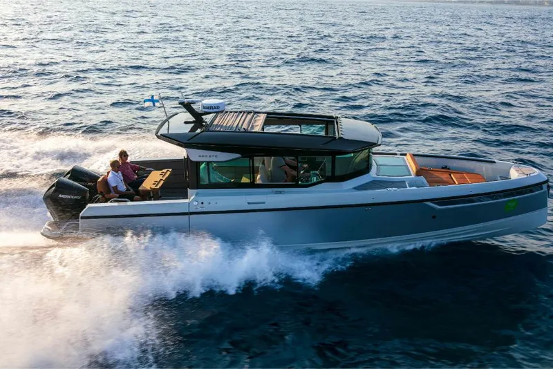 Slide: The Image of 2023 Saxdor 320 GTC motorboat cruising on open water. - 4