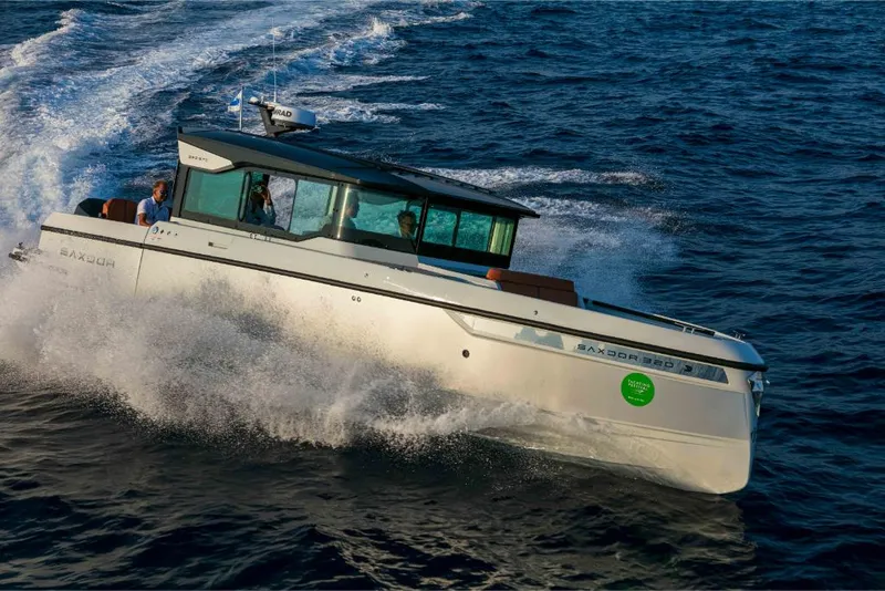 Slide: The Image of 2023 Saxdor 320 GTC motorboat cruising on open water. - 47