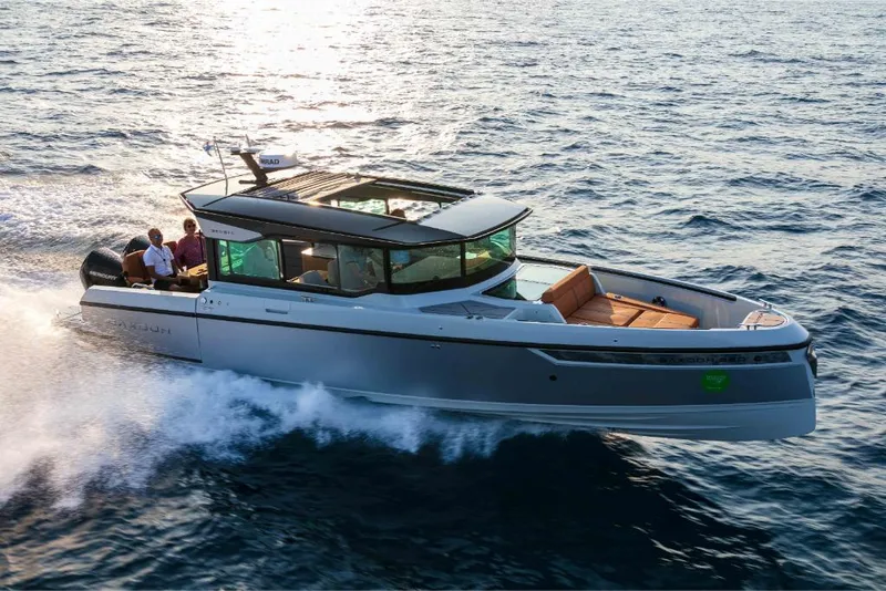 Slide: The Image of 2023 Saxdor 320 GTC cruising on open water at sunset. - 7