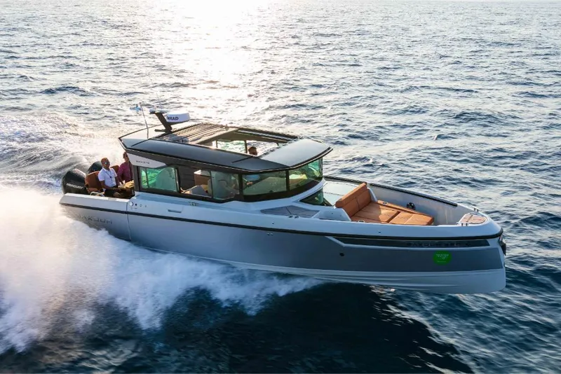 Slide: The Image of 2023 Saxdor 320 GTC cruising on open water at sunset. - 8