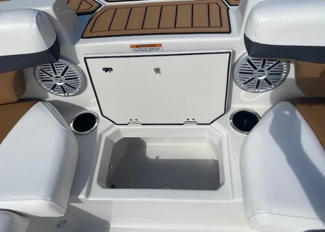 Slide: The Image of 2022 Starcraft SVX 191 OB boat interior with storage compartment, cup holders, and speakers. - 14