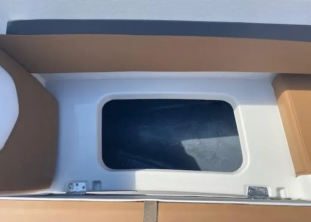Slide: The Image of 2022 Starcraft SVX 191 OB boat storage compartment with tan and white interior. - 15