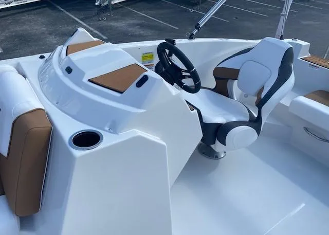 Slide: The Image of 2022 Starcraft SVX 191 OB boat cockpit with steering wheel and seating. - 18