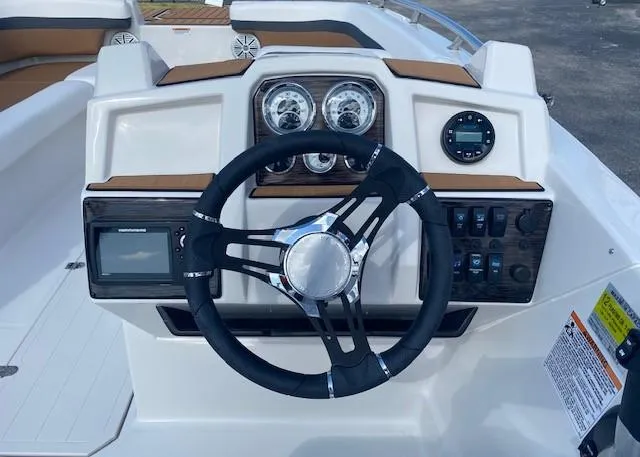 Slide: The Image of 2022 Starcraft SVX 191 OB boat dashboard with steering wheel and control panel. - 19