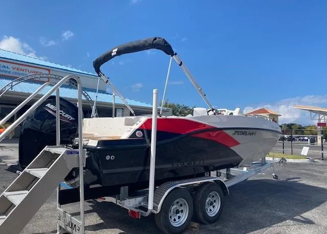 Slide: The Image of 2022 Starcraft SVX 191 OB boat on a trailer in a parking lot. - 2