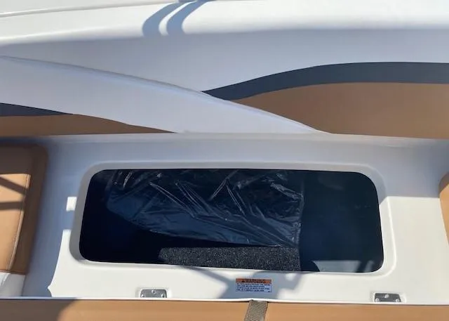 Slide: The Image of 2022 Starcraft SVX 191 OB boat storage compartment with brown and white interior. - 26