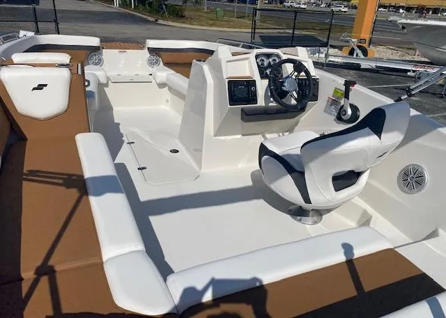 Slide: The Image of 2022 Starcraft SVX 191 OB boat interior with white and brown seating, steering console, and controls. - 31