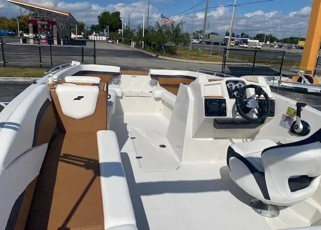 Slide: The Image of 2022 Starcraft SVX 191 OB boat interior with white and brown seating, steering console, and dashboard. - 32