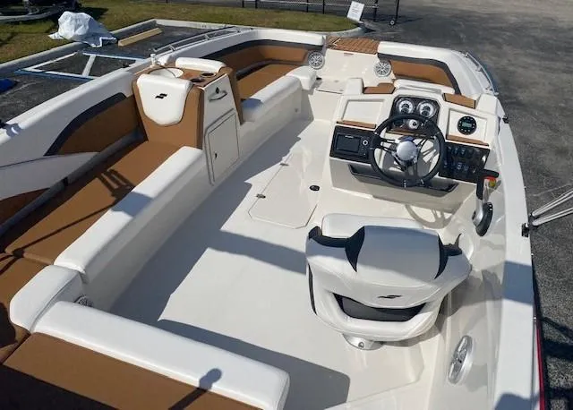 Slide: The Image of 2022 Starcraft SVX 191 OB boat interior with white and brown seating. - 34