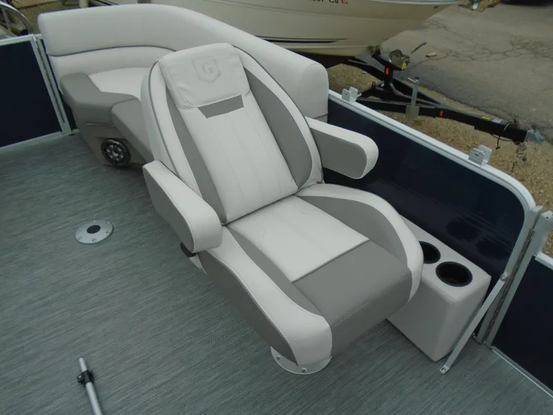 Slide: The Image of 2023 Godfrey 2286SBCX boat interior with luxurious seating and cup holders. - 3