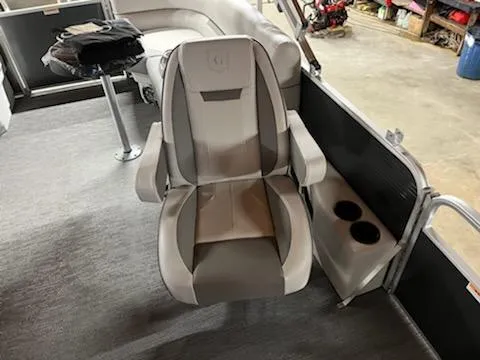 Slide: The Image of 2023 Godfrey 2286SBCX boat interior with captain's chair and cup holders. - 5
