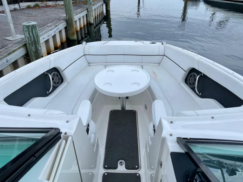 Slide: The Image of 2015 Sea Ray 240 Sundeck boat interior with seating and table. - 3