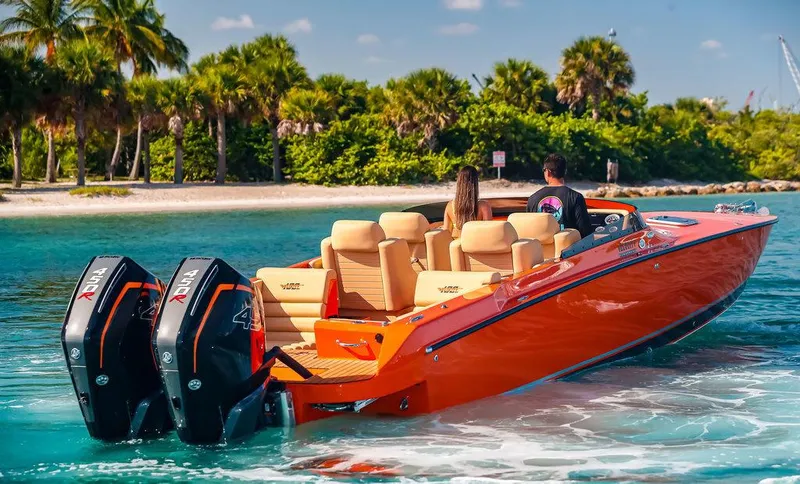 Slide: The Image of 2024 Velocity 430VRX speedboat with twin outboard engines near tropical beach. - 2