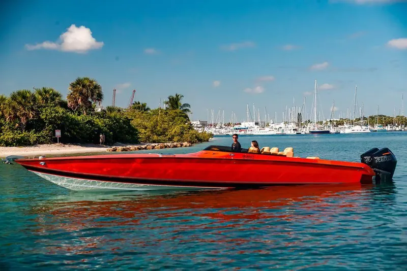 Slide: The Image of 2024 Velocity 430VRX speedboat cruising near a marina on a sunny day. - 3