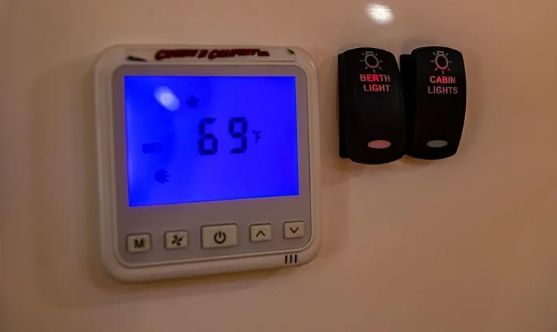 Slide: The Image of Digital thermostat and light switches in 2024 Velocity 430VRX boat cabin. - 5