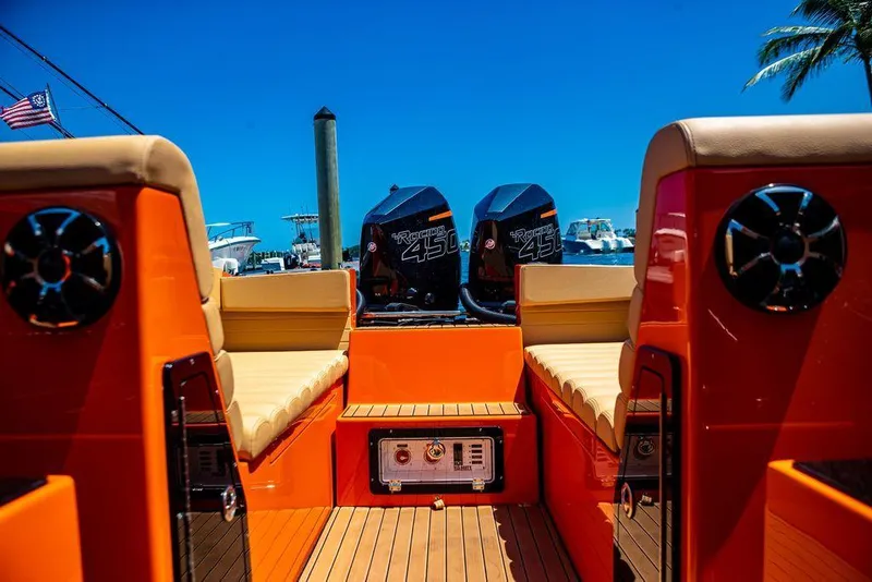 Slide: The Image of 2024 Velocity 430VRX boat with twin outboard engines and orange interior. - 6