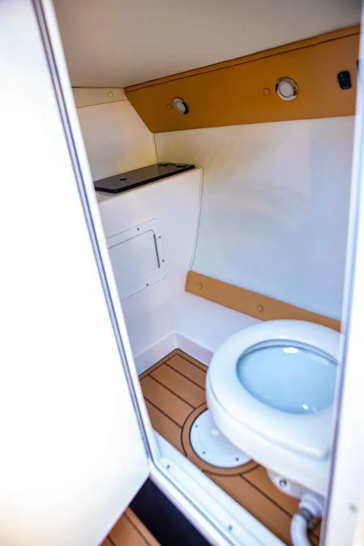 Slide: The Image of 2024 Velocity 430VRX boat bathroom with modern fixtures and wooden flooring. - 7