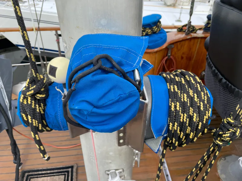 Slide: The Image of Sailboat rigging with blue covers and ropes on a 1974 custom center cockpit. - 9
