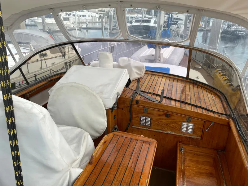Slide: The Image of 1974 Custom Center Cockpit boat with wooden interior, docked at a marina. - 5
