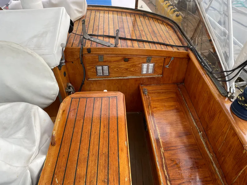 Slide: The Image of 1974 custom center cockpit with polished wood finish and white seating. - 4