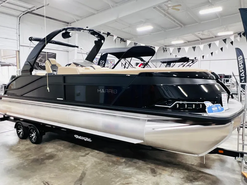 The Image of 2024 Harris 250 Grand Mariner V10 400 pontoon boat in showroom display. - 0