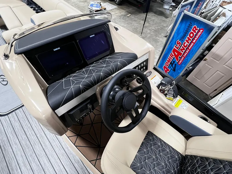 Slide: The Image of 2024 Harris 250 Grand Mariner V10 400 boat dashboard with dual screens and steering wheel. - 10