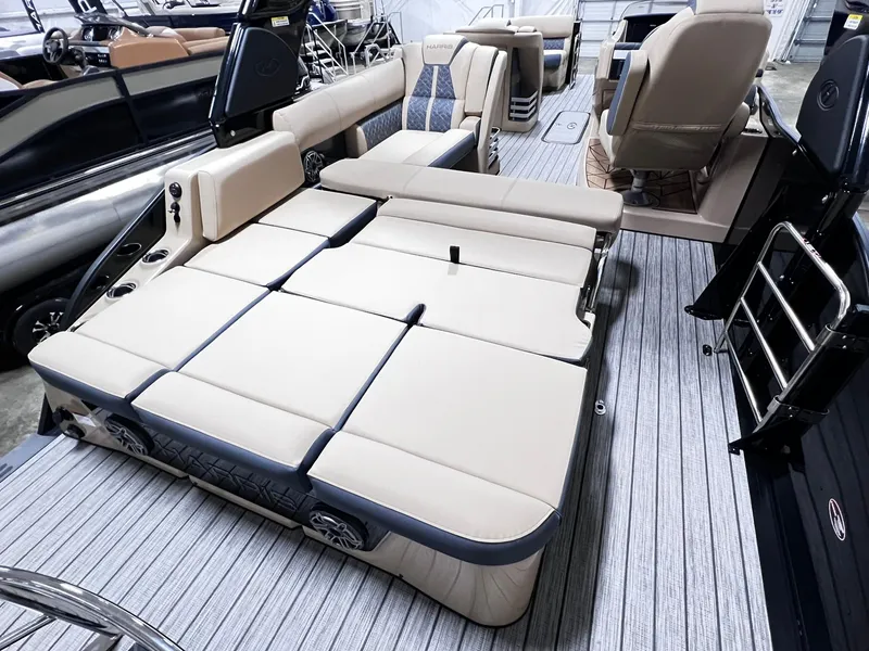 Slide: The Image of 2024 Harris 250 Grand Mariner V10 400 boat interior with beige seating and modern design. - 17