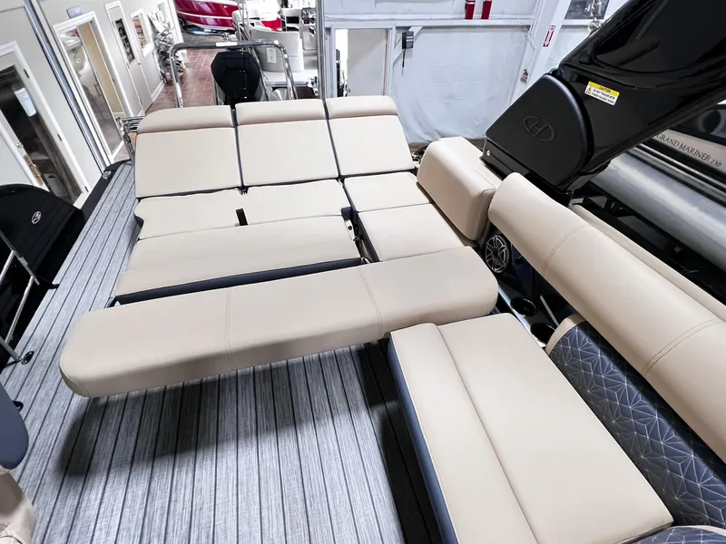 Slide: The Image of 2024 Harris 250 Grand Mariner V10 400 boat interior with beige seating and modern design. - 19