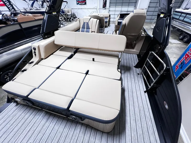 Slide: The Image of 2024 Harris 250 Grand Mariner V10 400 boat interior with beige seating and modern design. - 16