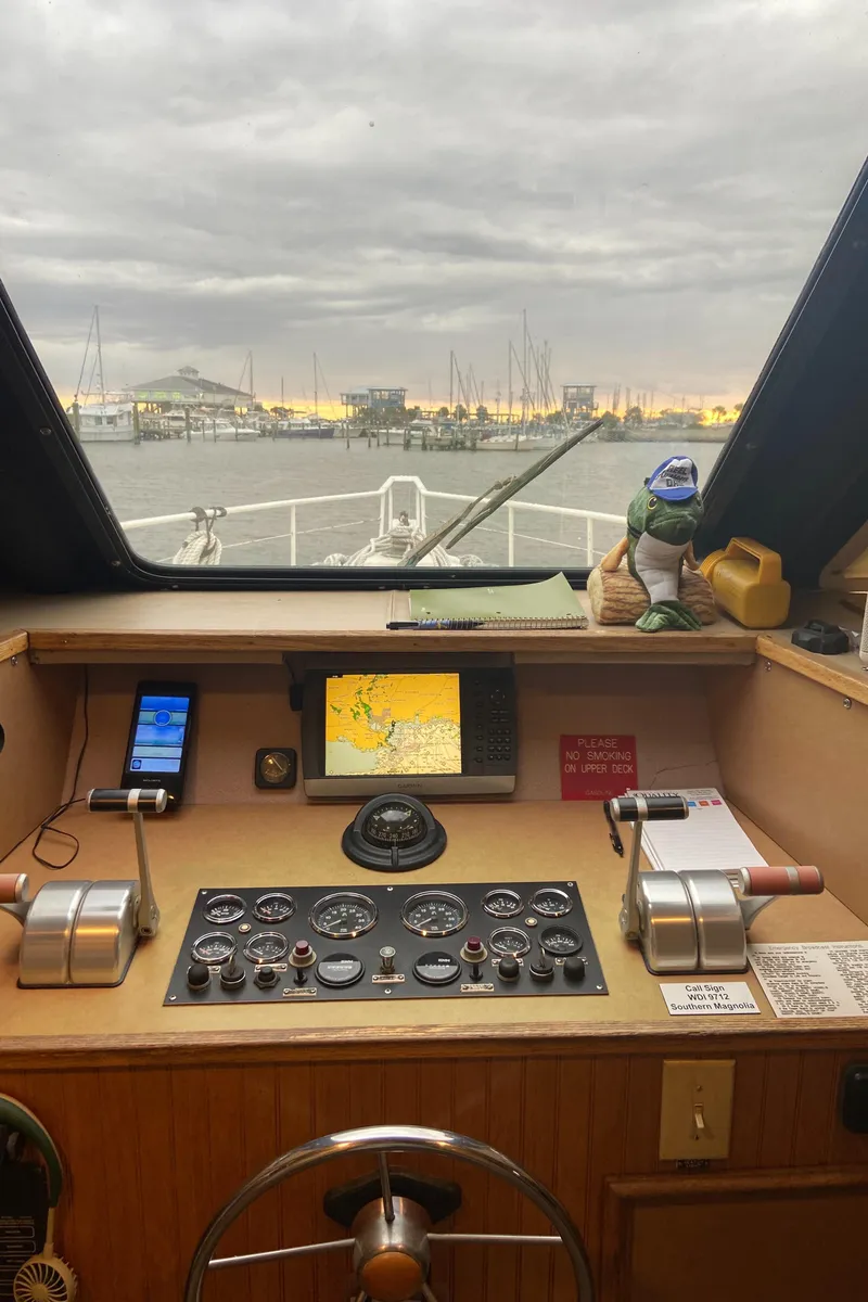 Slide: The Image of Boat cockpit with navigation equipment, overlooking a harbor at sunset. Custom Mothership, 1995. - 12