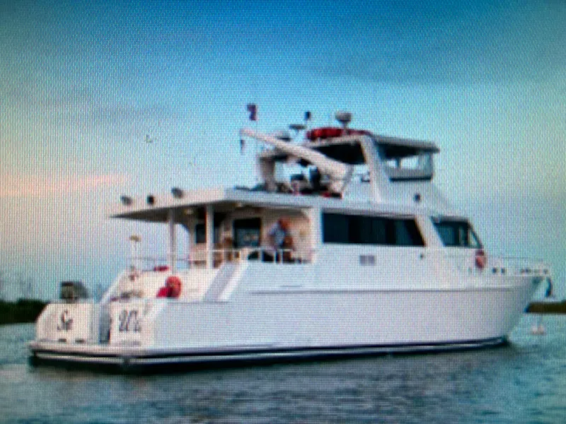 The Image of Custom 1995 Mothership yacht on calm waters under a clear sky. - 2