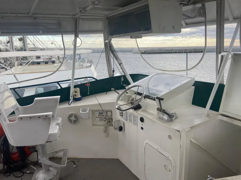 Slide: The Image of Helm of 1995 Custom Mothership boat with steering wheel and control panel. - 4