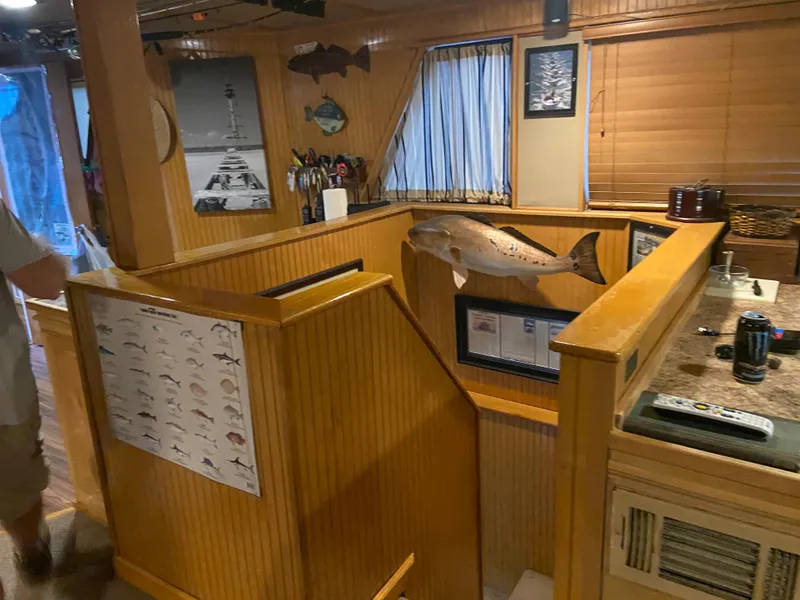 Slide: The Image of Interior of a 1995 Custom Mothership with wood paneling, fish decor, and nautical elements. - 9